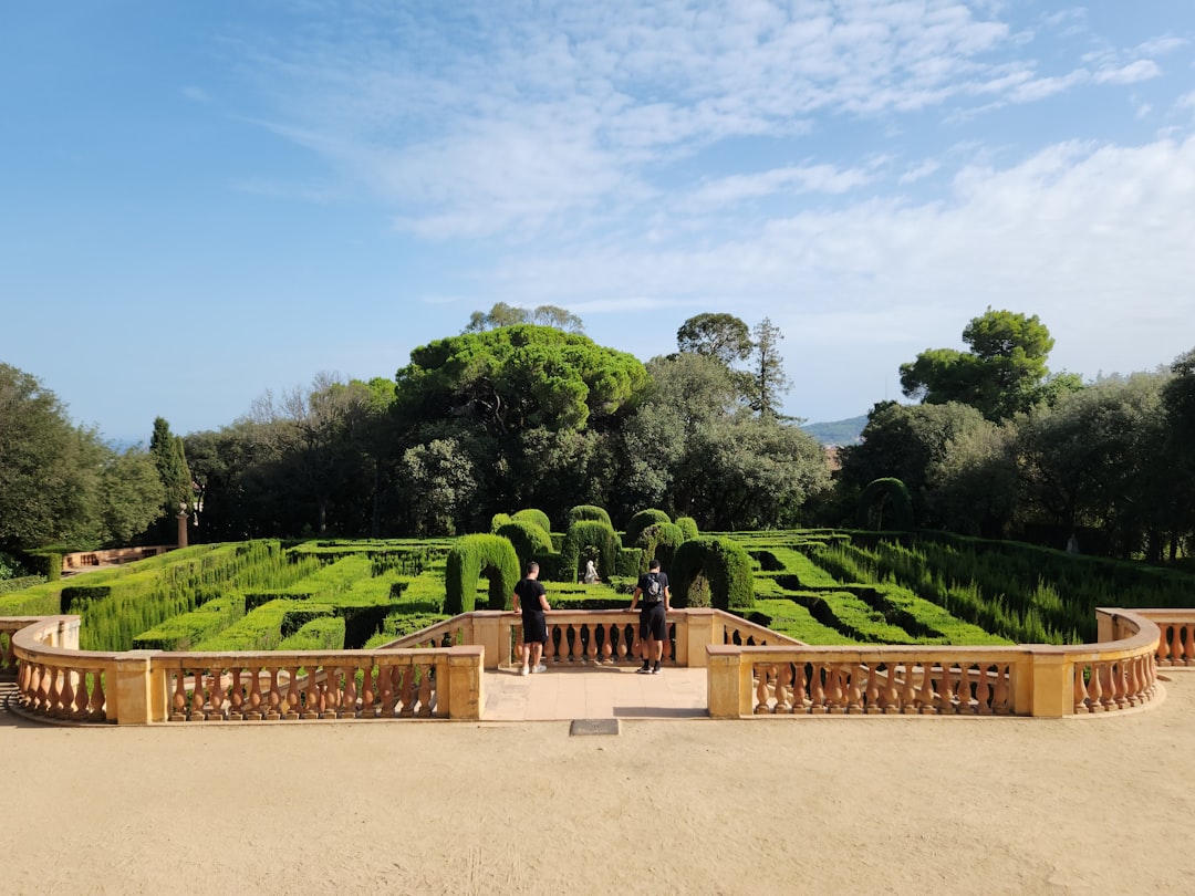 Gardener pruning hedges in sunny garden on Costa del Sol, Spain during maintenance work