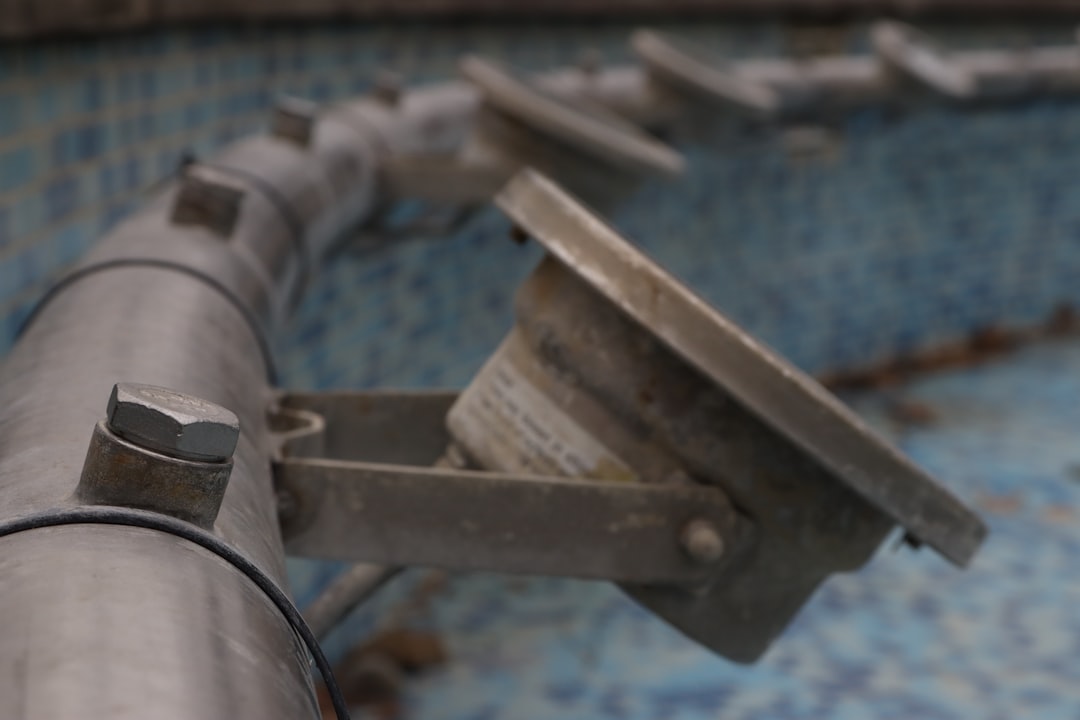 Close-up of a swimming pool pump and filter unit during a maintenance check